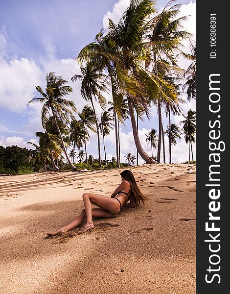 Woman Wearing Bikini Laying on Seashore