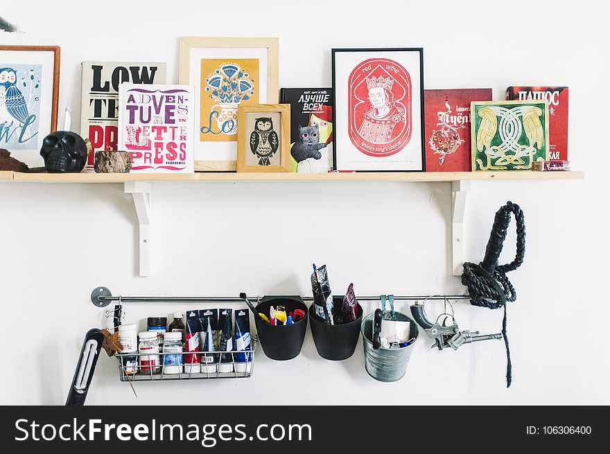 Assorted Wooden Photo Frames on White Wooden Wall Mounted Ledge