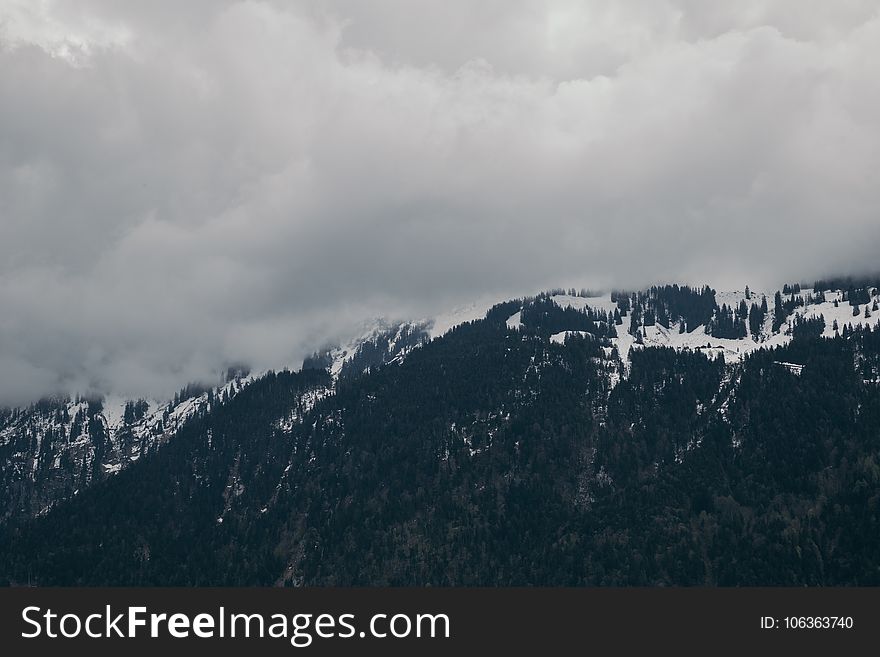 Snow-capped Mountain Under Cloudy Sky