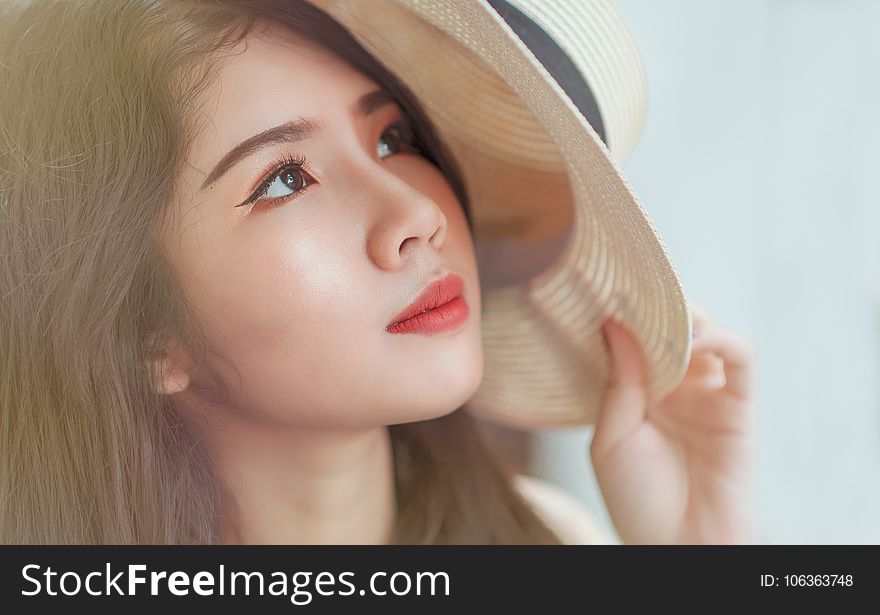 Woman Holding White Hat