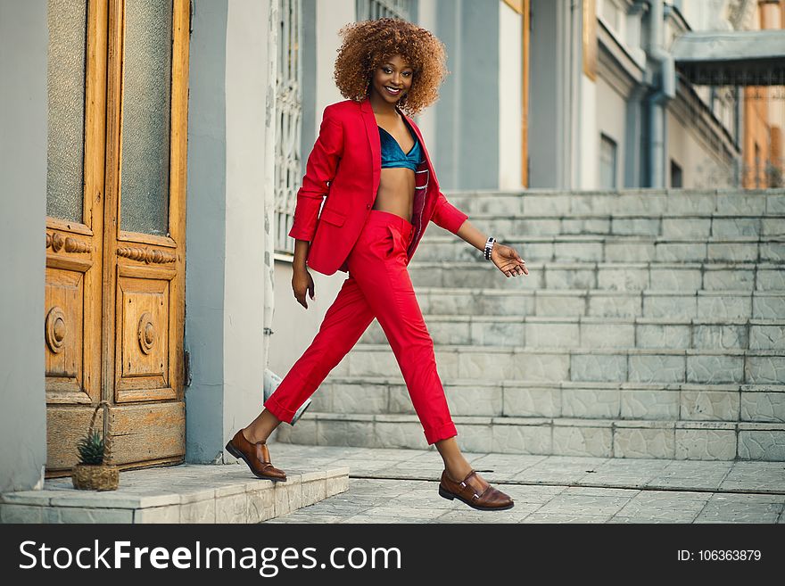 Woman Wearing Red Suit and Pants Outfit