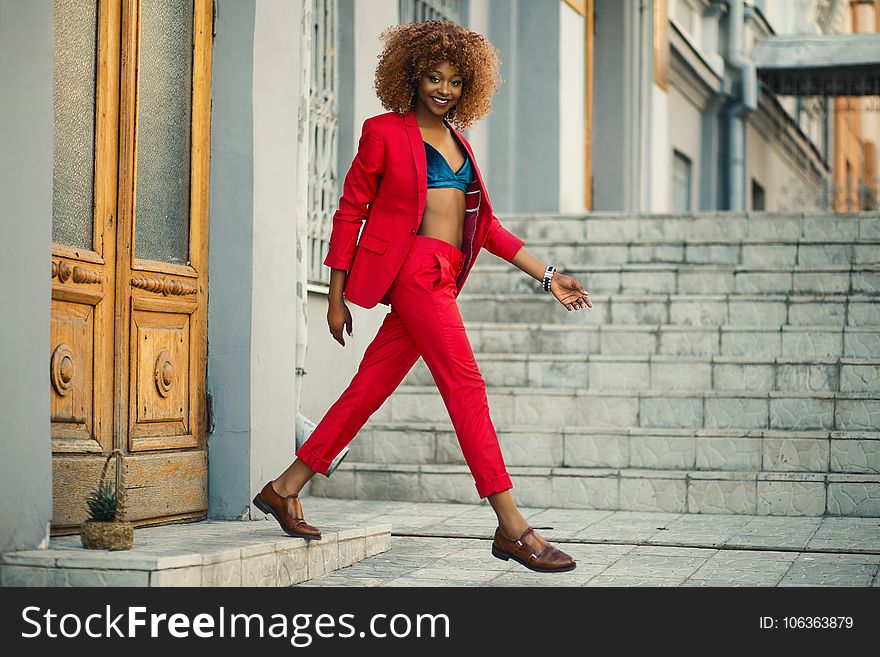 Woman Wearing Red Suit And Pants Outfit