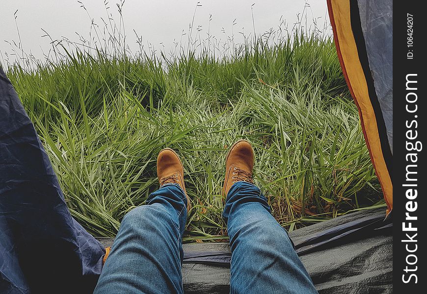 Photo of Man in Blue Jeans and Work Boots