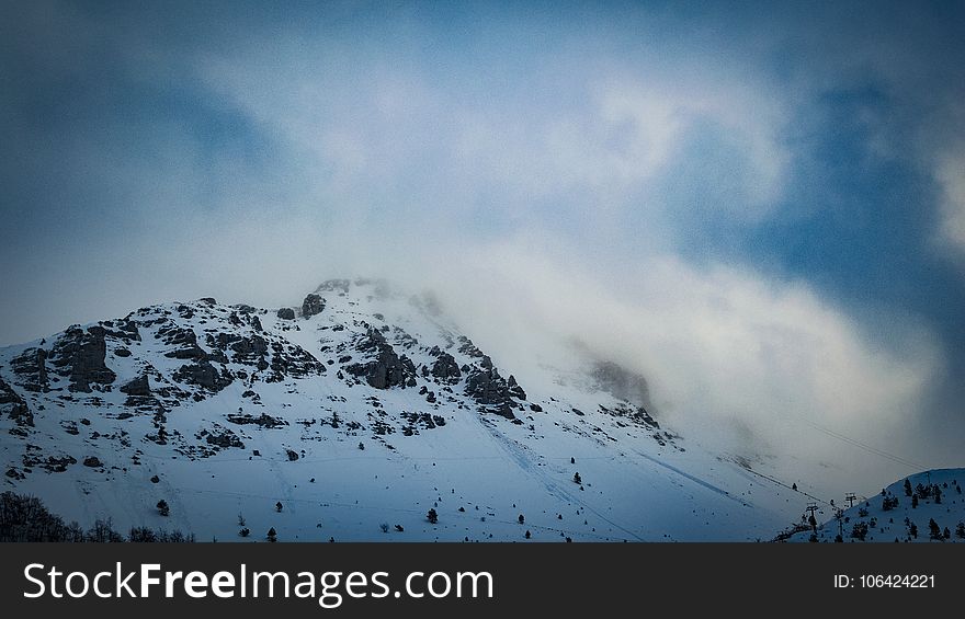 Snow Covered Mountain Under Cloudy Blue Sky