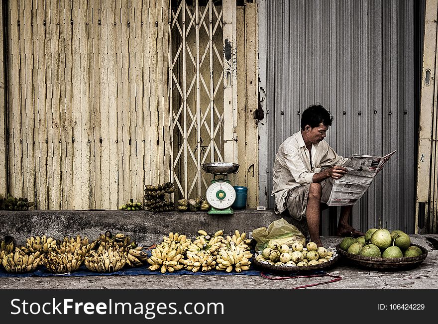 Man Sitting Near Fruits