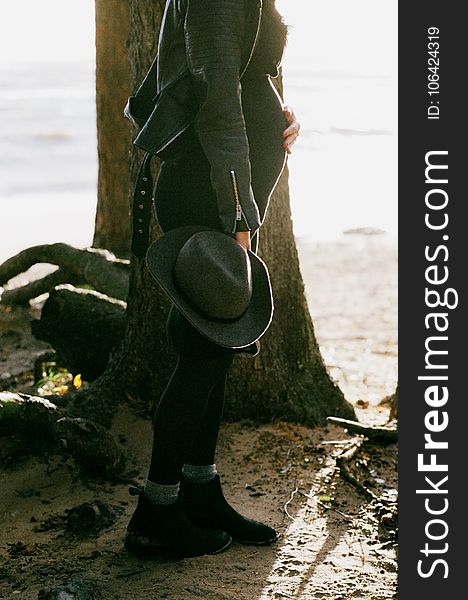 Photo Of Pregnant Woman Standing Behind The Tree