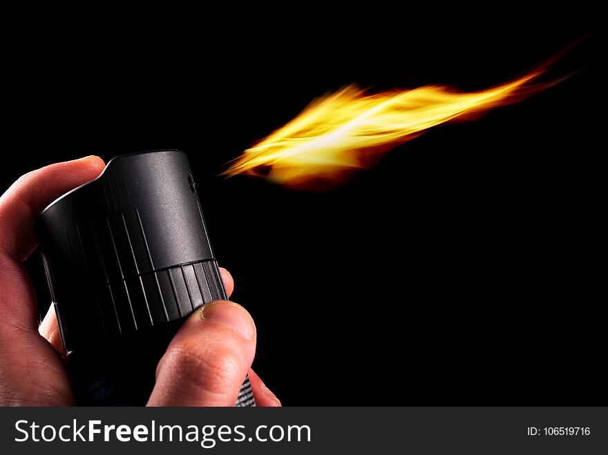 Deodorant can and fire blazing out of bottle isolated on black background. Close up