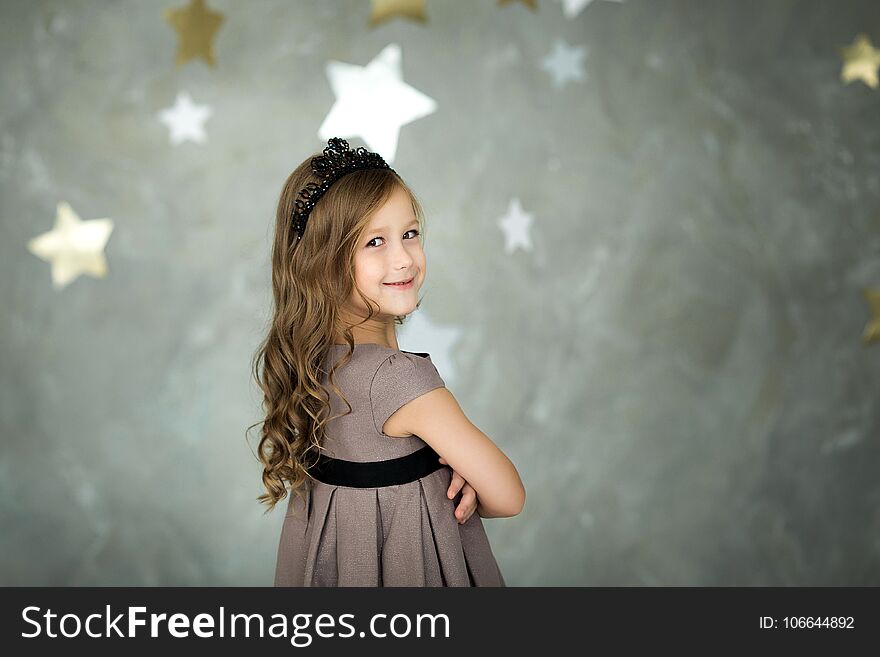 Portrait of a happy little girl on a background of stars