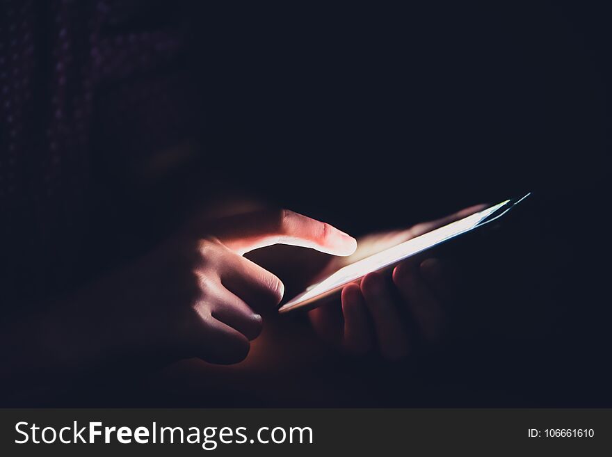 Hands Are Playing Smartphones In Dark Rooms.