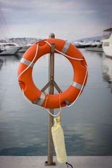 Bright Orange Lifebuoy On The Sea Water Background. Athens, Greece Royalty Free Stock Photo