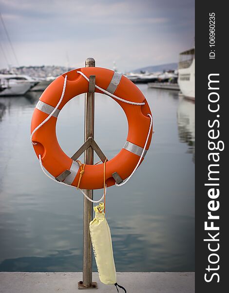 Bright Orange Lifebuoy On The Sea Water Background. Athens, Greece