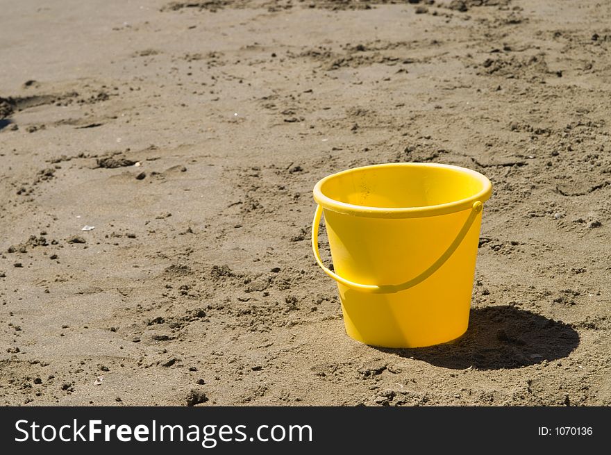 Yellow pail in a beach. Yellow pail in a beach