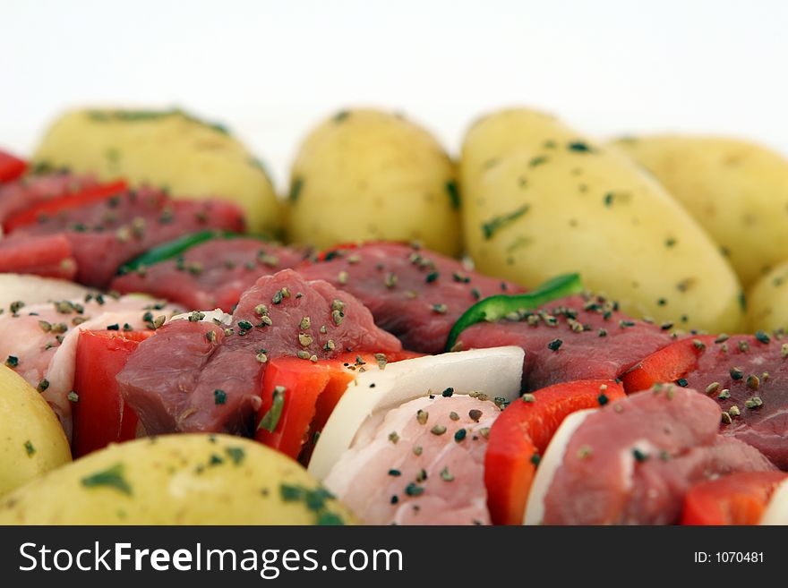 Turkish beef, lamb, and pork kebabs with potato on skewers