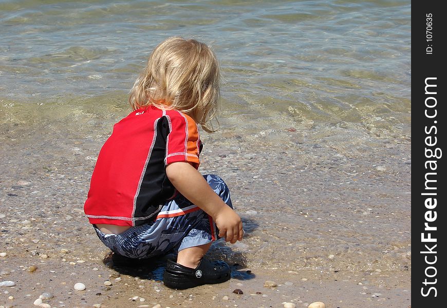 Child Playing In Ocean
