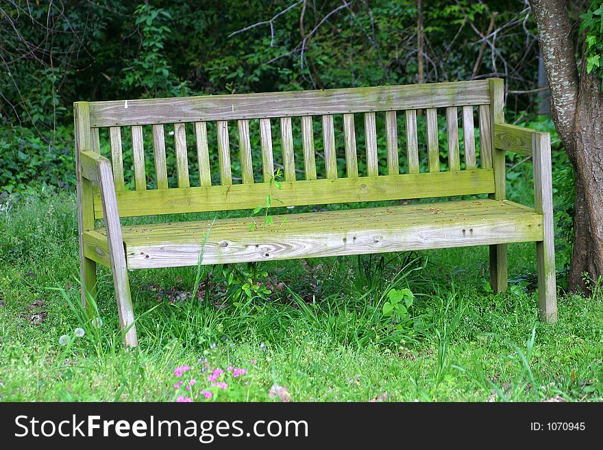 An old weathered bench in the yard. An old weathered bench in the yard