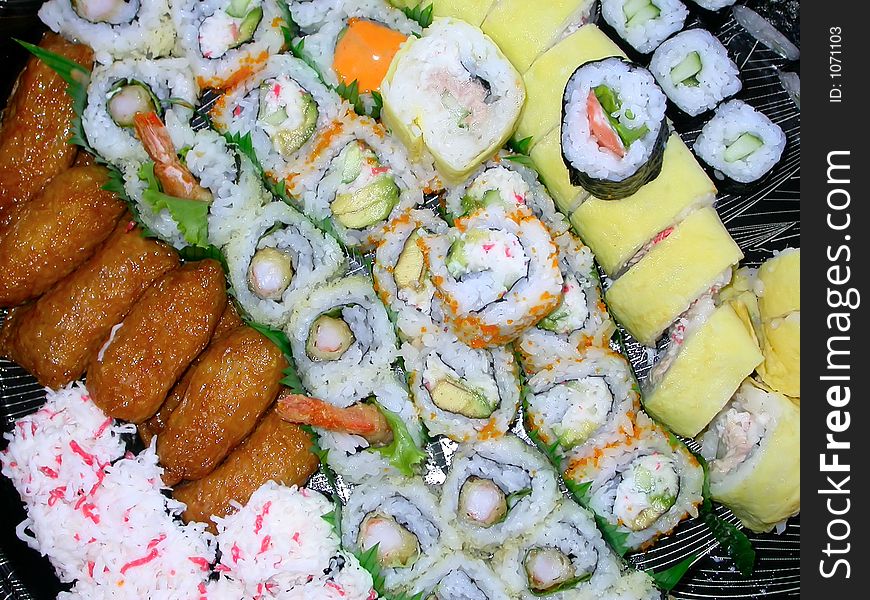 A platter of various kinds of sushi...shrimp tempura, california rolls, salmon rolls, cucumber rolls, and the house special. A platter of various kinds of sushi...shrimp tempura, california rolls, salmon rolls, cucumber rolls, and the house special