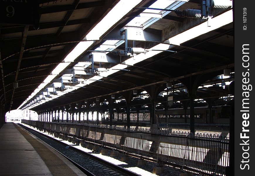 One of the tracks in a train depot-this is the starting point. This is a high contrast graphic image, with strong lines radiating out towards the viewer from the end of a tunnel in the distance. One of the tracks in a train depot-this is the starting point. This is a high contrast graphic image, with strong lines radiating out towards the viewer from the end of a tunnel in the distance.