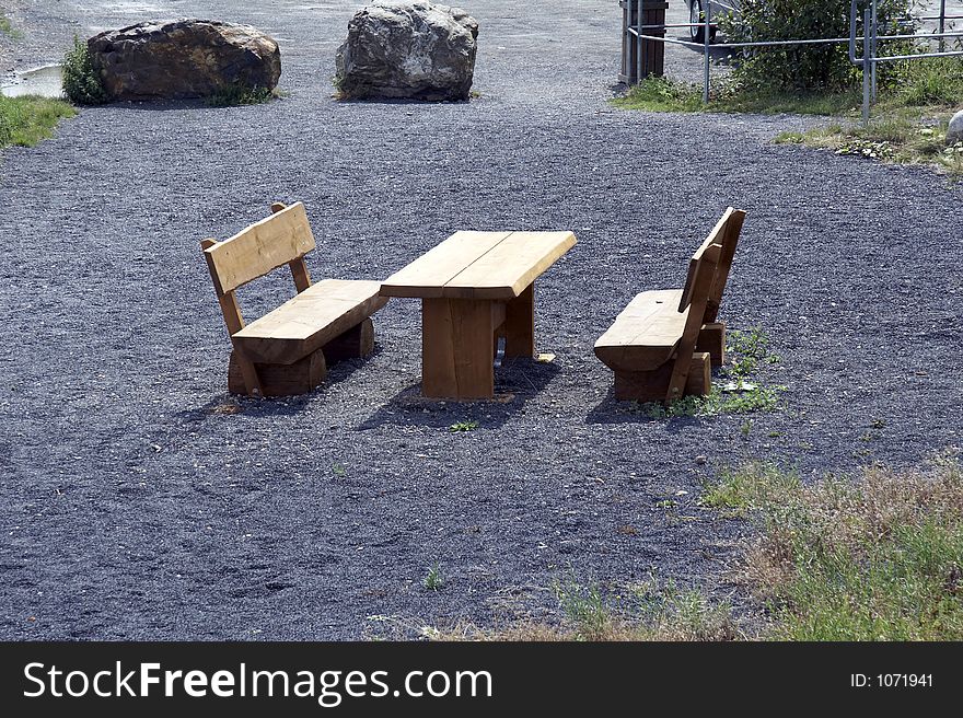Picnic area with bench and table at parking lot