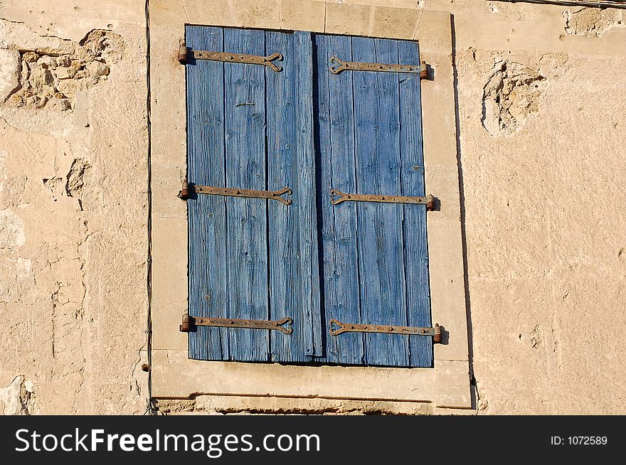 CLosed shutters in blue painted wood. CLosed shutters in blue painted wood.