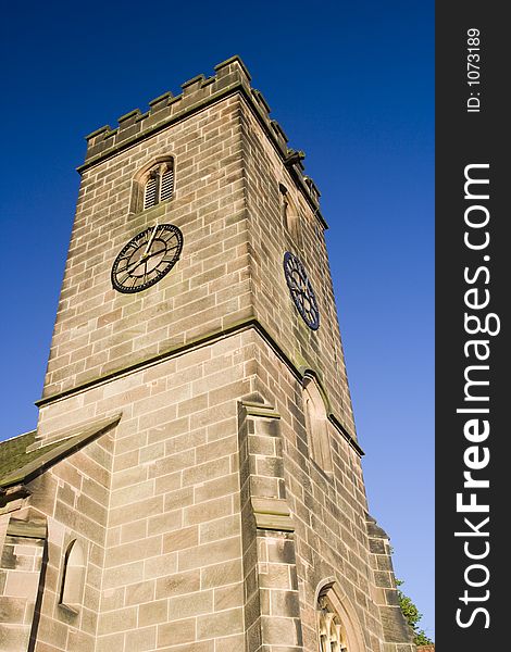 Traditional English stone church tower on summer evening. Traditional English stone church tower on summer evening.