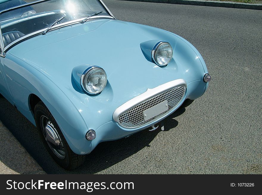 Front of vintage, light blue sportscar. Front of vintage, light blue sportscar