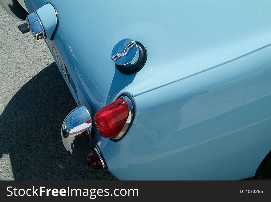 Detail of classic, light blue English sportscar. Detail of classic, light blue English sportscar