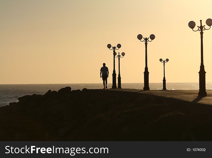 Man walking down a sunstrip. Man walking down a sunstrip