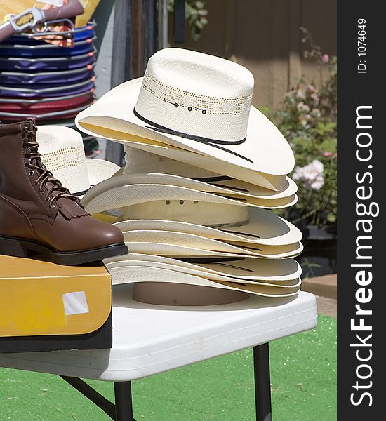 Cowboy hats stacked on table.
