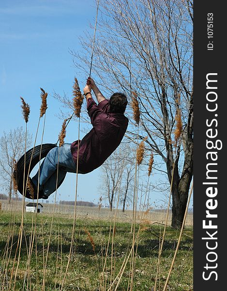 Active man on swing tire