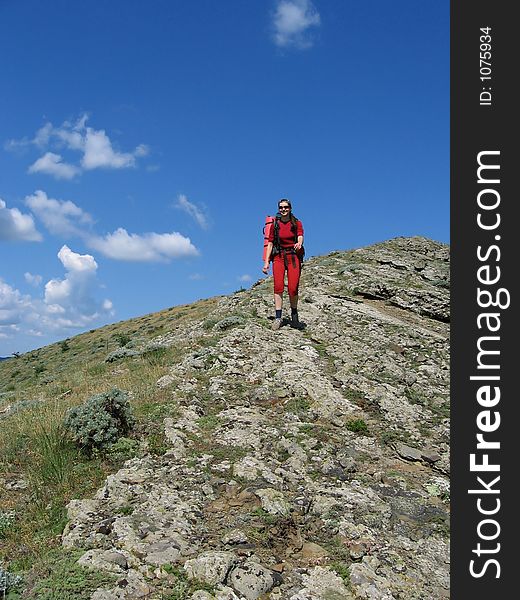 Women for red going along mountain. Women for red going along mountain