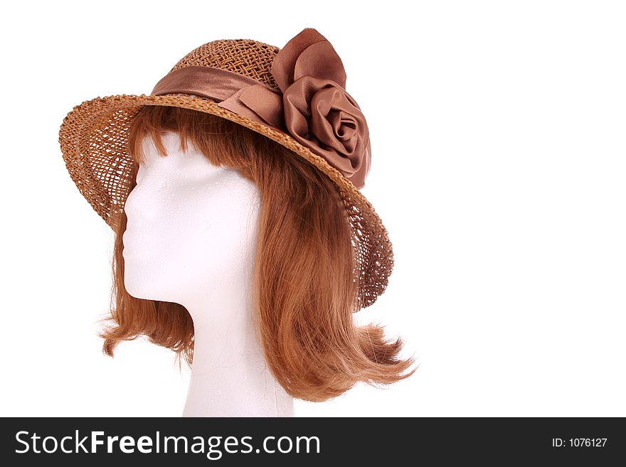A 1940s style ladies hat on a manequin head isolated on white