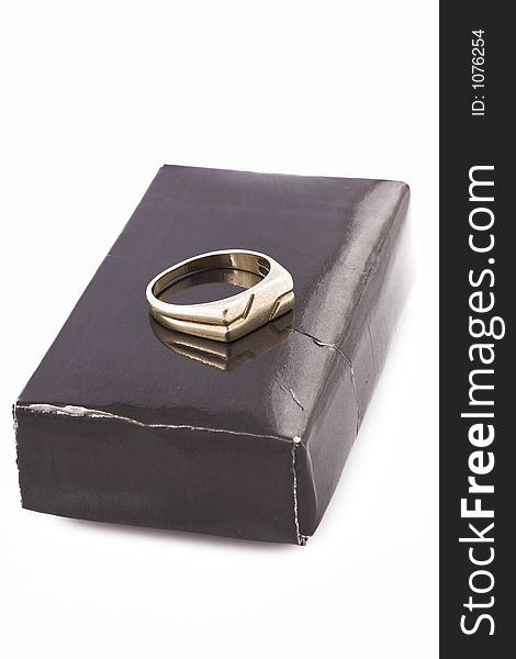 Wedding ring on black box, simbolising divorce