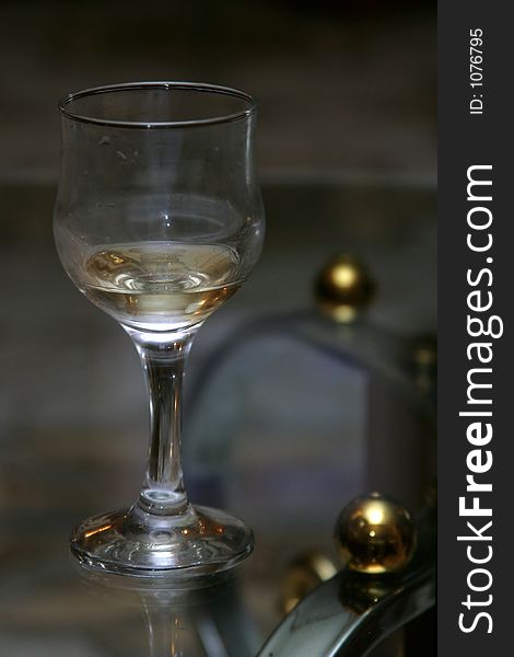 Wine glass with a wine on a transparent table. Wine glass with a wine on a transparent table