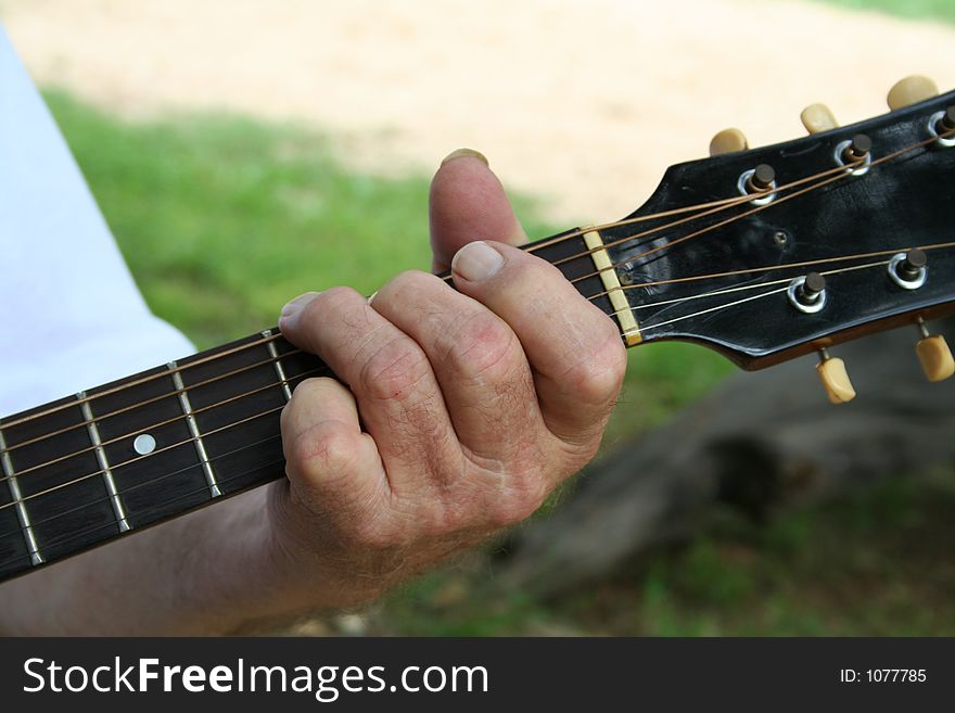 Music aged hand playing guitar