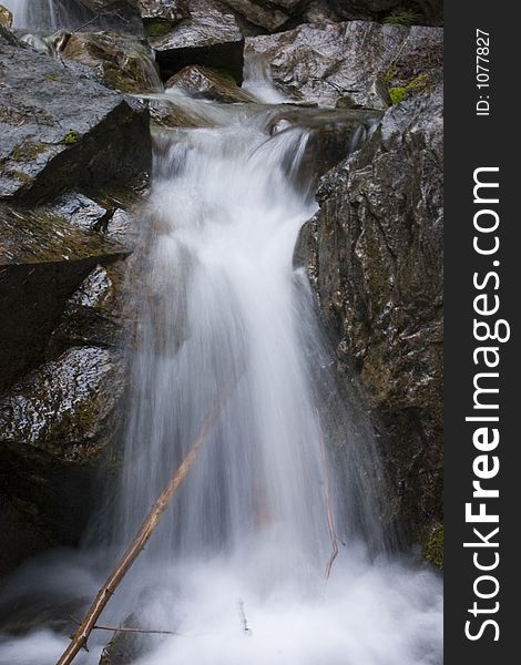 Stream of water gently flowing over rocks. Stream of water gently flowing over rocks