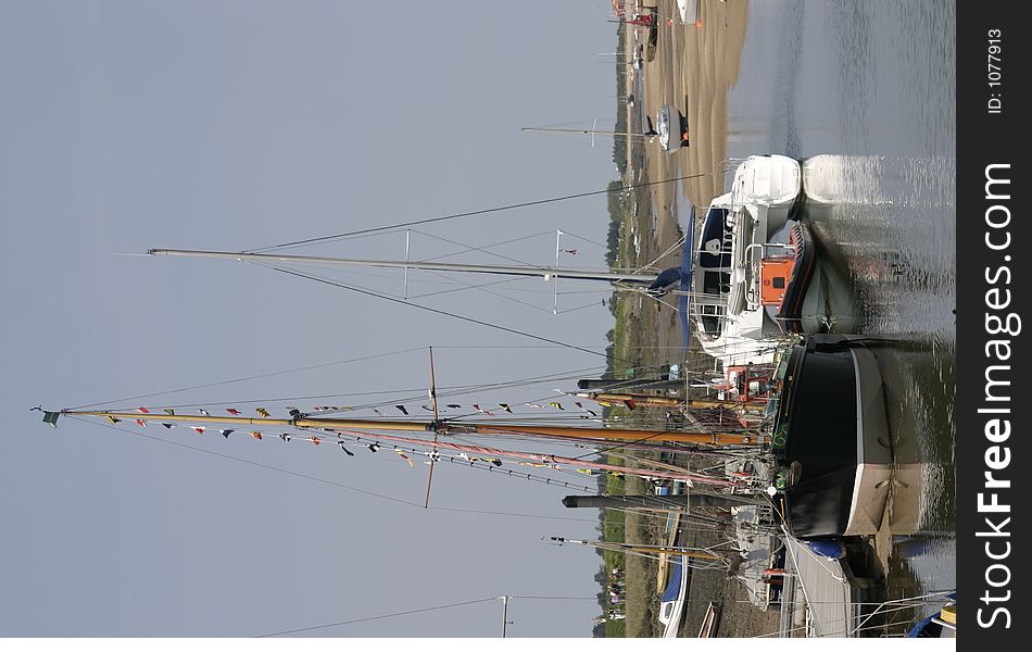 Tall boats sitting at the quayside at low tide. Tall boats sitting at the quayside at low tide