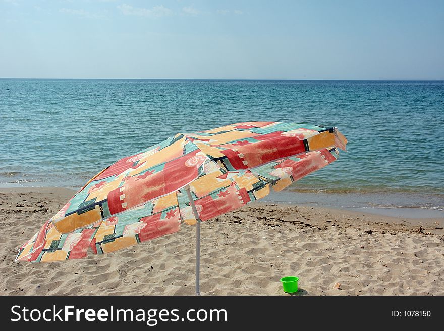 Sea beach with umbrella in front