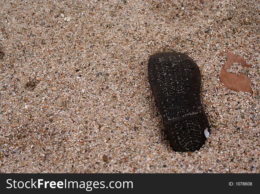 Sand and black shoe. Sand and black shoe