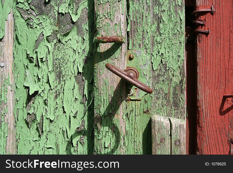 Green door and a rusty key. Green door and a rusty key