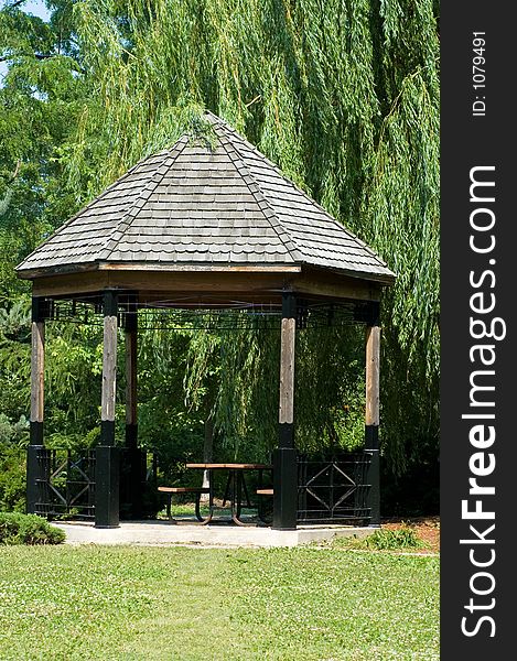 Peaceful looking wooden gazebo, in a local park.