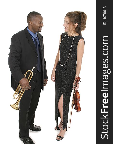 A beautiful female violinist and a handsome male trumpet player standing together holding their instruments. Shot isolated on white background. A beautiful female violinist and a handsome male trumpet player standing together holding their instruments. Shot isolated on white background.