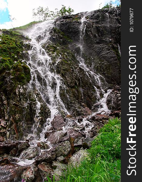 Small waterfall and mountain. Altay. Russia.