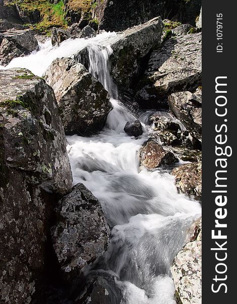 Small Waterfall And Mountain.