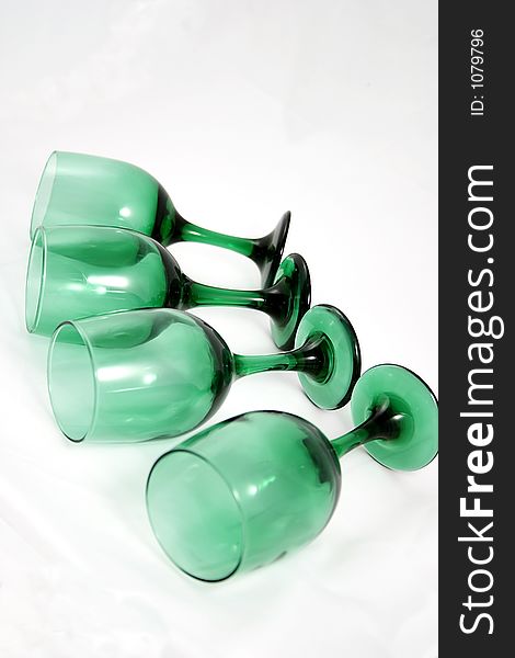 Four green water goblets. Four green water goblets.