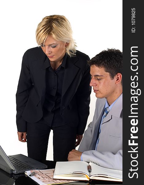 Businessman working at his desk and talking to a secretary. Businessman working at his desk and talking to a secretary