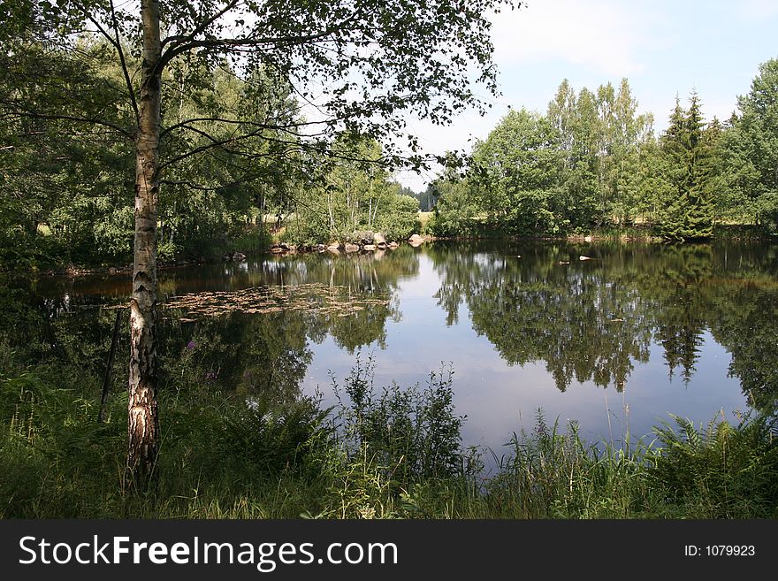 Romantic lake in summer, reflecting the trees around. Romantic lake in summer, reflecting the trees around