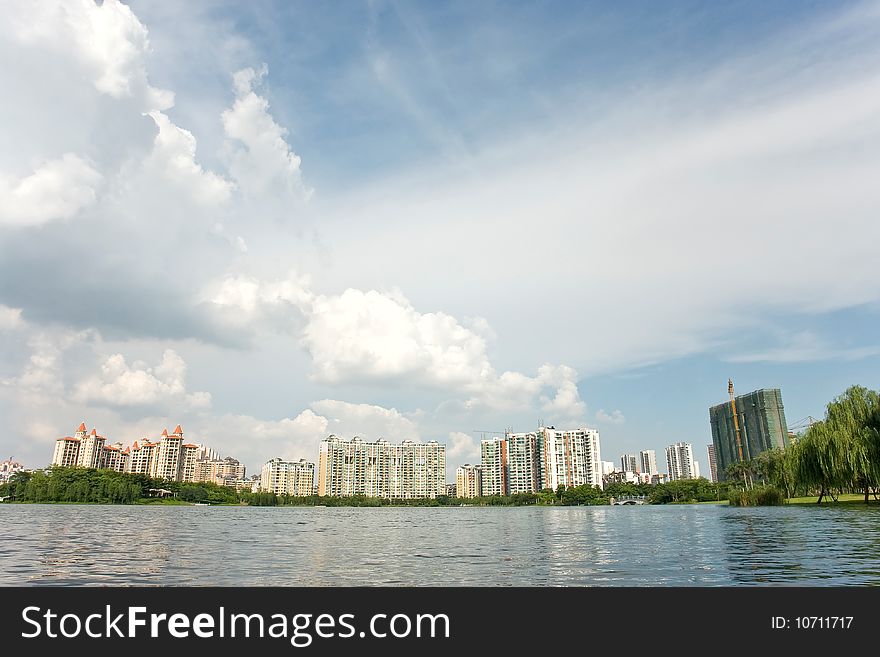 Chinese peaceful community with some modern buildings beside the lake in a beautiful day,Foshan,Canton,China. Chinese peaceful community with some modern buildings beside the lake in a beautiful day,Foshan,Canton,China