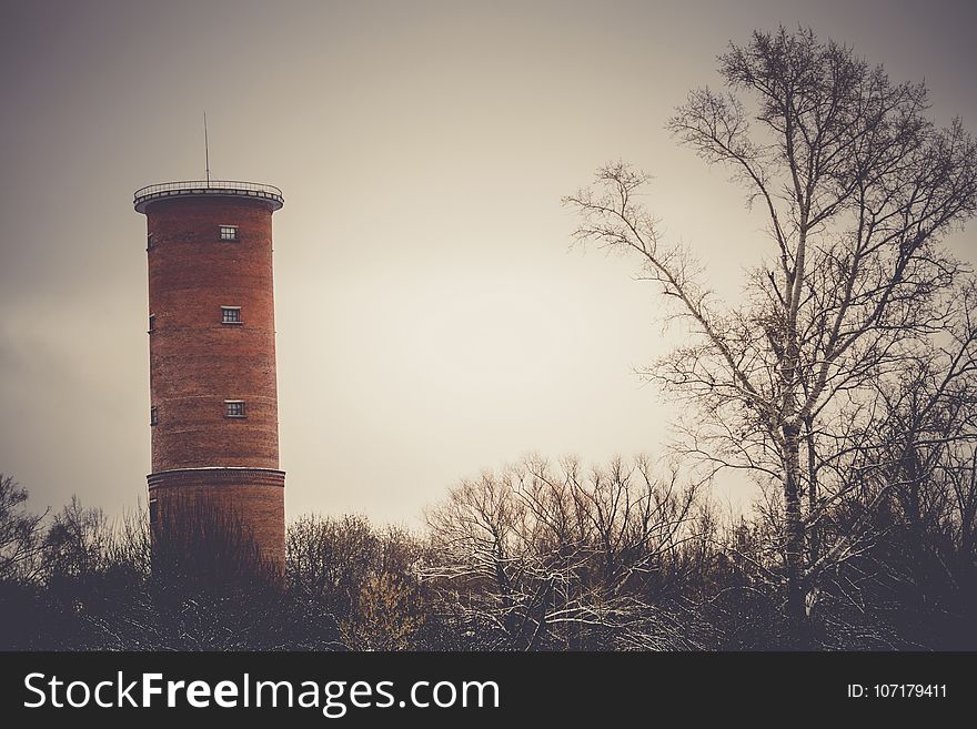 Vintage style red brick water tower of an old factory, filtered. Vintage style red brick water tower of an old factory, filtered.