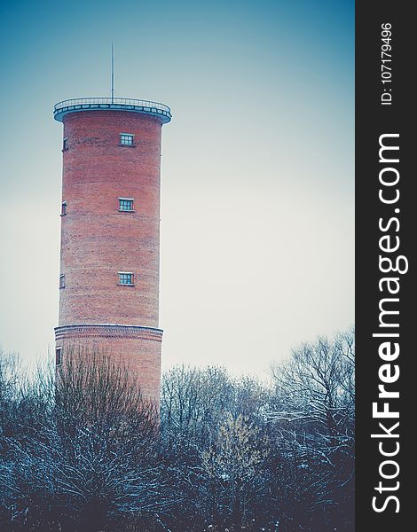 Vintage style red brick water tower of an old factory, filtered. Vintage style red brick water tower of an old factory, filtered.