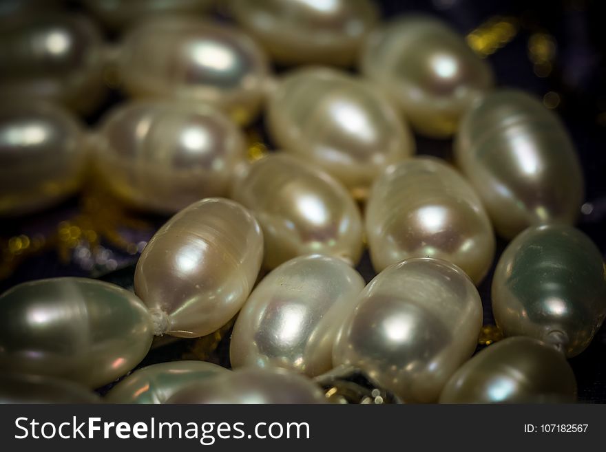 Natural white freshwater pearl necklace close up filtered background. Natural white freshwater pearl necklace close up filtered background.